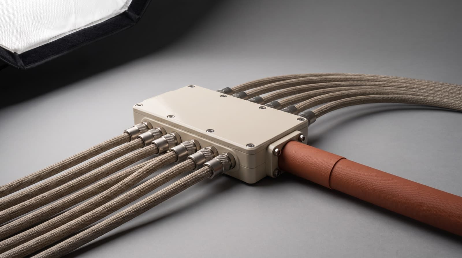 Woven cords converging into a machined junction ring